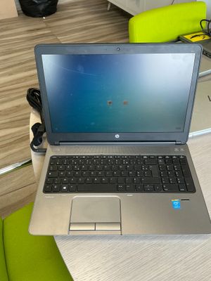 a laptop that is sitting on a desk in a room