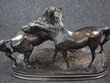 two horses that are standing next to each other