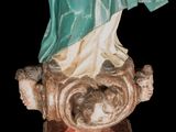an old statue of a woman holding a baby in her arms