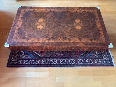 a large wooden box on a rug on a hard wood floor