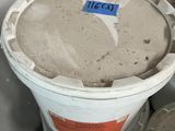 several buckets of cement sitting on top of a table