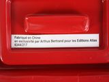 a close up of a red mailbox with a sticker on it