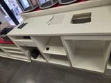 a white desk with a computer on top of it