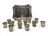 an image of a group of silver cups and trays on a white surface