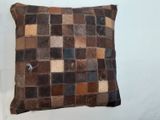 brown patchwork leather pillow with a patchwork design on the front