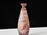 purple glass vase on a white table with a black background