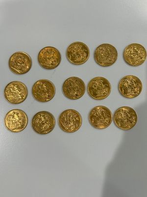 a close up of a person ' s hand holding a bunch of gold coins