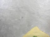 a piece of cheese on a piece of bread on a plate