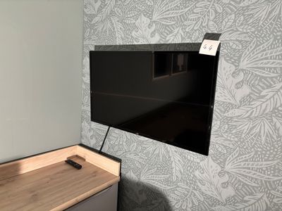 a flat screen tv mounted on a wall in a room