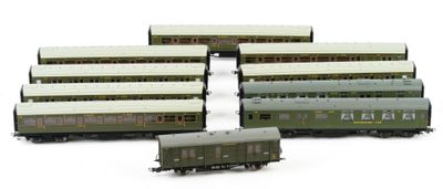 four trains sitting next to each other on a white surface