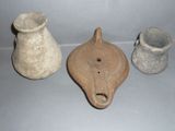 three clay vases are sitting next to each other on a table