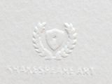 white paper with a crest and laurels on it