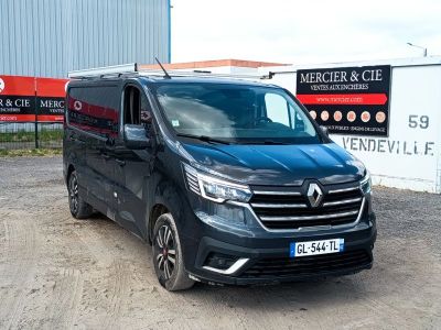 the black van is parked in front of a building