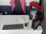 a computer desk with a keyboard and a monitor on it