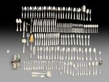 an assortment of silverware including spoons, knives, and spoons