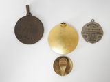 three different types of medals are displayed on a white surface