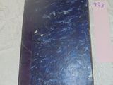 a blue book sitting on a table with a price tag
