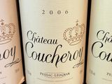 several bottles of wine are lined up on a shelf