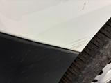 a close up of a car ' s front bumper and tire