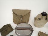 an assortment of military items including a canteen, canteen bag, and other items