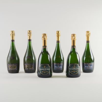 six bouteilles de champagne sont alignées