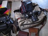a bag with a camera and some other items on the floor
