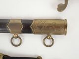 a close up of a pair of brass hooks on a wall
