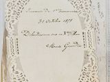 an old book with a white lace cover on it