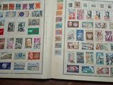 an open book with stamps on it sitting on top of a table