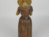 bronze figurine of a woman with a hat on her head