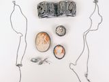 a picture of a necklace, a coin, and other jewelry on a white surface
