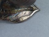 a close up of a metal object with a bird on it