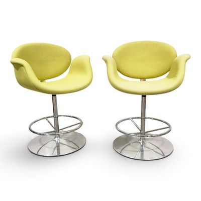 pair of yellow swivel chairs with chrome bases