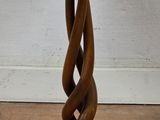 a wooden candle holder with a candle on top of it