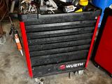 a black tool box with tools in it in a garage