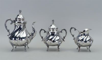 trois pièces en argent pour le thé et le café sur une table