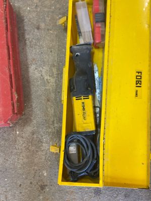 a yellow box with tools in it sitting on the floor
