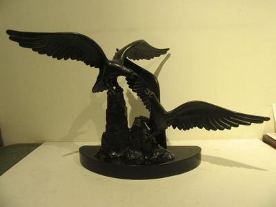 a statue of a bird that is sitting on a table