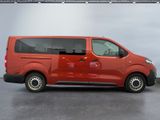 the red van is parked in the garage with its door open
