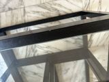 a glass table with a metal frame and a glass top