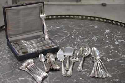 silver spoons and spoon spoons sitting on a table