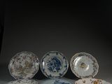cinq assiettes sont disposées en rangée sur une surface grise