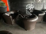 three chairs and a table in a room with graffiti on the wall