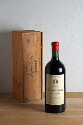 a bottle of wine sitting next to a wooden box