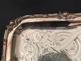 a silver tray with a decorative design on it