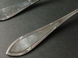 two spoons and a fork sitting on a table