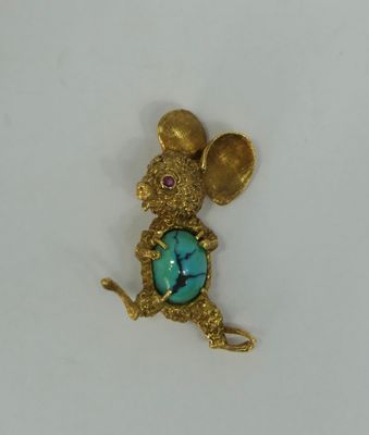 an image of a gold mouse with a turquoise stone in its mouth