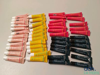 de nombreux tubes de dentifrice et du dentifrice sur une table