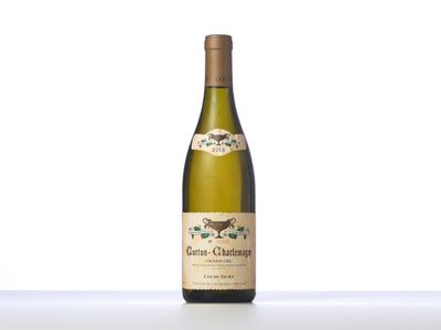 the bottle of white wine is sitting on the table