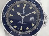 an image of a wrist watch with a blue dial on a silver bracelet